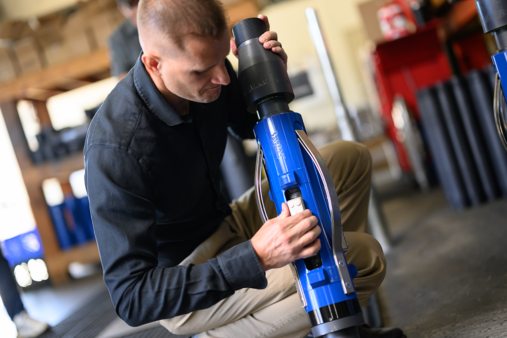 A man inspecting a TechTAC Slimline Tubing Anchor Catcher