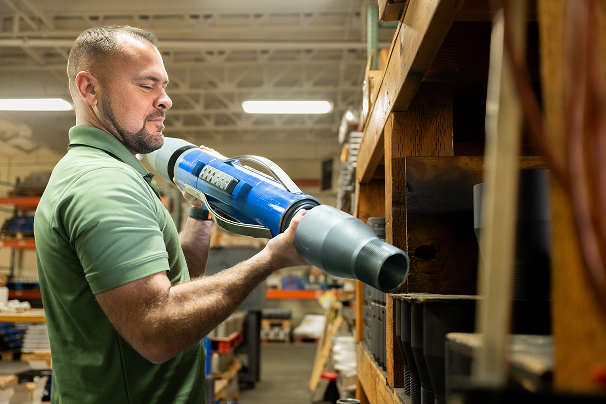 Person holding a tubing anchor