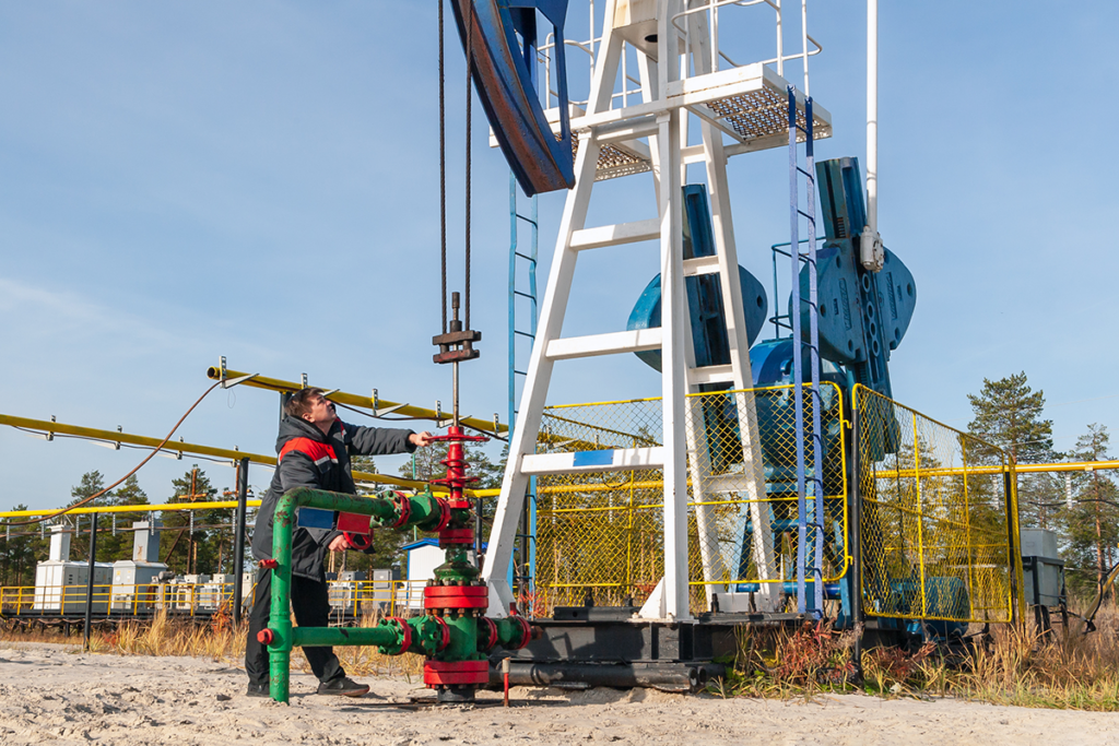 An oil worker checks a well