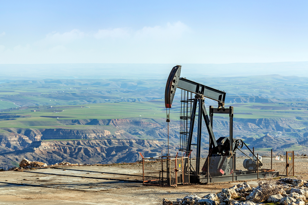 Pumpjack with a canyon in the background