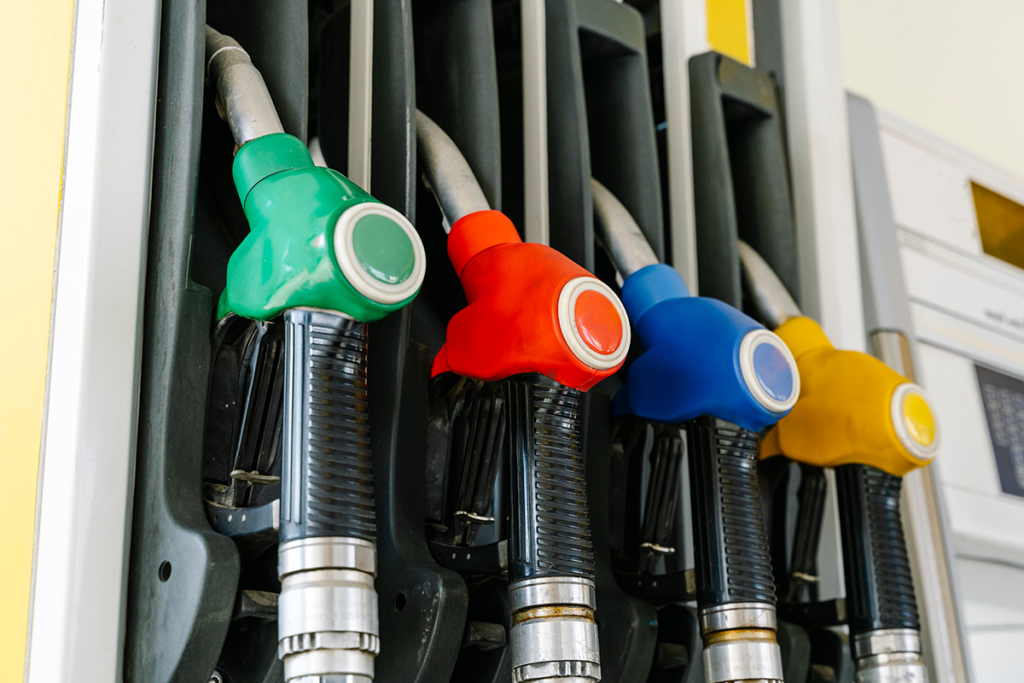 A gas pump with 4 colored nozzles
